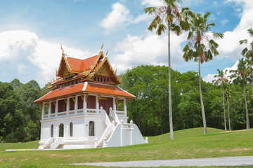 Beautiful chapel of Buddha at middle pool and green grass all around