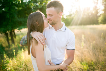 Couple in love - Beginning of a Love Story. A man and a girl with a tattoo on the nature