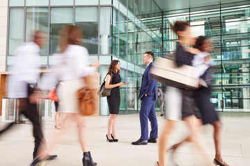 People passing through the busy foyer of a business building