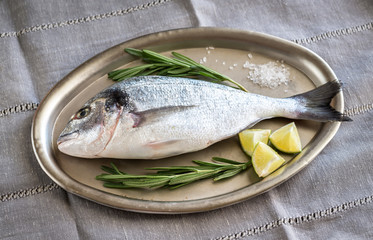 Fresh dorada with ingredients on the vintage tray