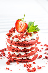 Delicious red cake with cream and berries close up.