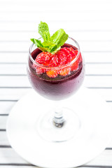 Cocktail with strawberries on a wooden table