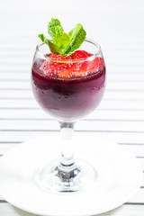 Cocktail with strawberries on a wooden table