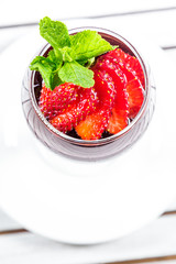 Cocktail with strawberries on a wooden table