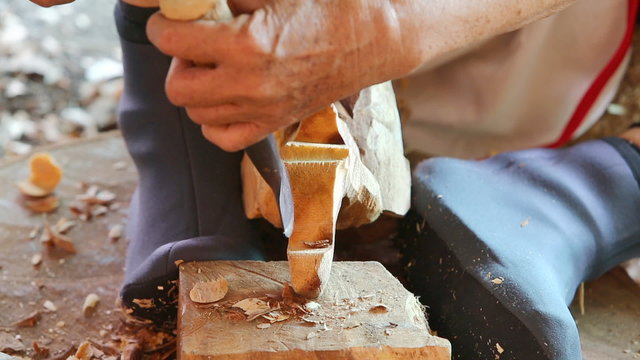 Hand of carver carving wood 