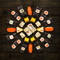 Set of sushi, maki and rolls isolated at wood