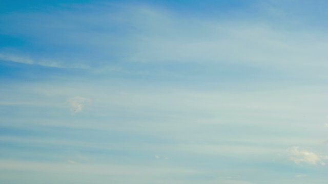 thin clouds run over the blue sky