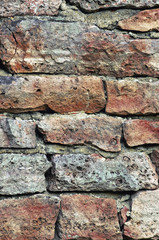 Stone wall macro closeup, vertical stonewall pattern background, old aged weathered red grey grunge limestone dolomite slate slab rock texture, natural grungy, beige, yellow, gray brick vintage