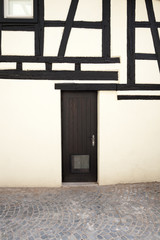 A typical Alsatian half-timbered house's wall with door, Strasbourg, Alsace, France