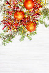 three orange Xmas baubles and twig on blank paper