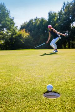 a ball is about to drop in the hole Close up on a winning swing
