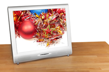 Christmas still life with red ball on screen of TV