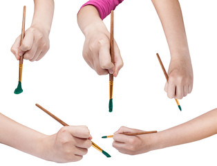 set of hands with art paintbrushes with green tips