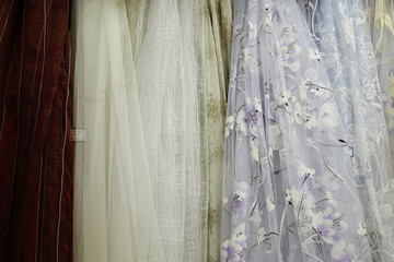 Tulle transparent fabric. It is used for windows. Background. Yellow, lilac.
