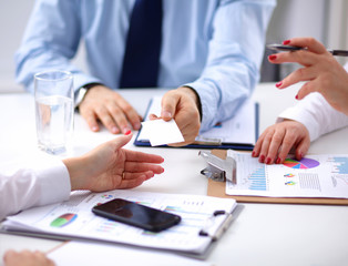 Attractive female doctor shaking a patient's hands in her office