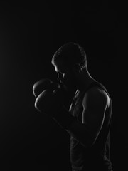 Athletic bearded boxer with gloves on a dark background - 90418677
