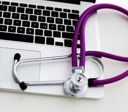 Stethoscope on laptop keyboard. Concept 3D image