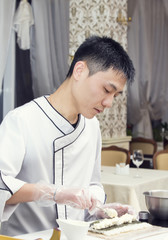 Obraz na płótnie Canvas Japanese chef preparing a meal in a restaurant