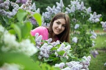 Fototapeta premium Beauty model girl with lilac flowers in summer