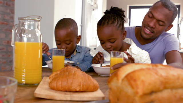 Happy Family Having Breakfast Together In The Morning