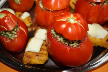 tomatoes stuffed with rice and polenta with melted cheese