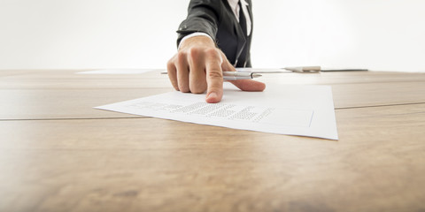 Business adviser showing to a piece of document with statistical