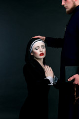 Halloween. A man and woman dressed as the clergy