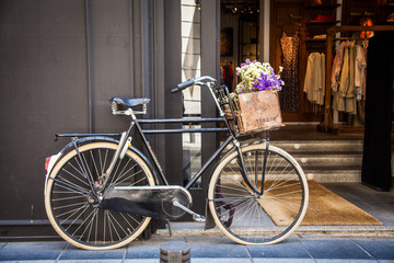 Fototapeta na wymiar Old bicycle with flowers in metal basket