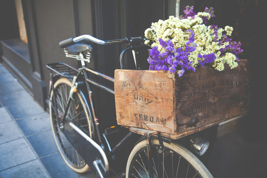 Old bicycle with flowers in metal basket