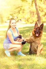 Beautiful young girl with dog in park