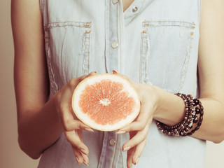Human holding grapefruit. Healthy diet food.