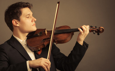 Man violinist playing violin. Classical music art