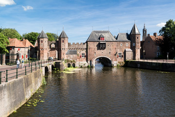 Fototapeta na wymiar Medieval fortress city wall gate Koppelpoort and Eem River in the city of Amersfoort - tourist destination near Amsterdam, Netherlands