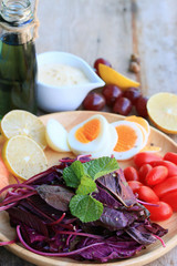 fresh red spinach salad and cream on wooden table
