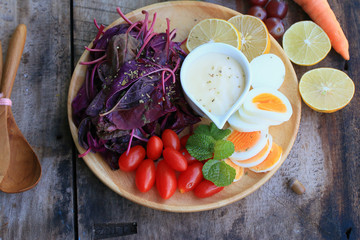 fresh red spinach salad and cream on wooden table