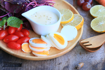 fresh red spinach salad and cream on wooden table
