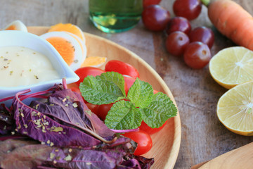 fresh red spinach salad and cream on wooden table