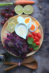 fresh red spinach salad and cream on wooden table
