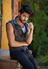 handsome man model dressed punk, hipster posing dramatic in grun