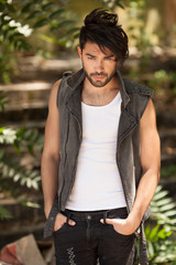 handsome man model dressed punk, hipster posing dramatic in grun