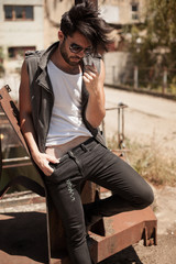 handsome man model dressed punk, hipster posing dramatic in grun