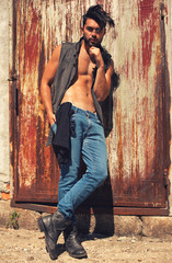 handsome man model dressed punk, hipster posing dramatic in grun