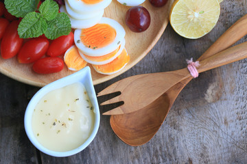 fresh red spinach salad and cream on wooden table