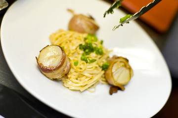 Bacon wrapped scallops and Fettuccine with tongs