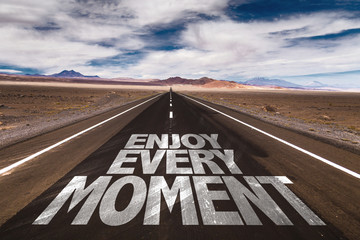 Enjoy Every Moment written on desert road
