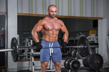 Fototapeta na wymiar Muscular strong man in the gym.
