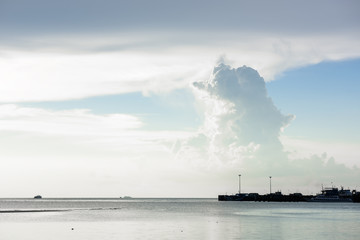 Fototapeta na wymiar Dusk big cute bear cloud blue sea and sky at Samui pier,Thailand