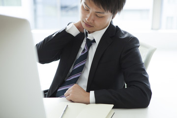 Businessman is holding the shoulder