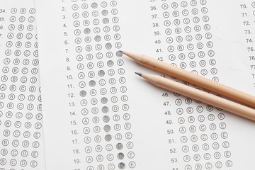 Standardized test form with answers bubbled in and a pencil, foc