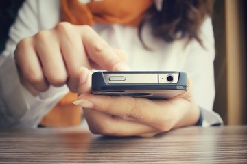 Businesswoman using smart phone in the cafe